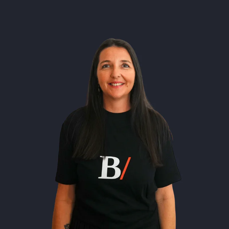 Heidi Hein, co-founder of Built With Skills, smiling in a black logo T-shirt